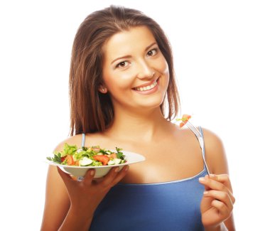 Mutlu kadın salata yiyor.