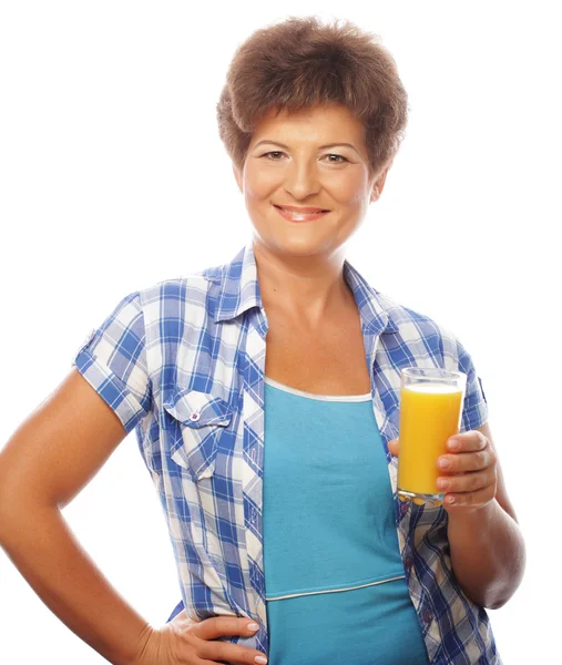 Mature happy woman with orange juice — Stock Photo, Image