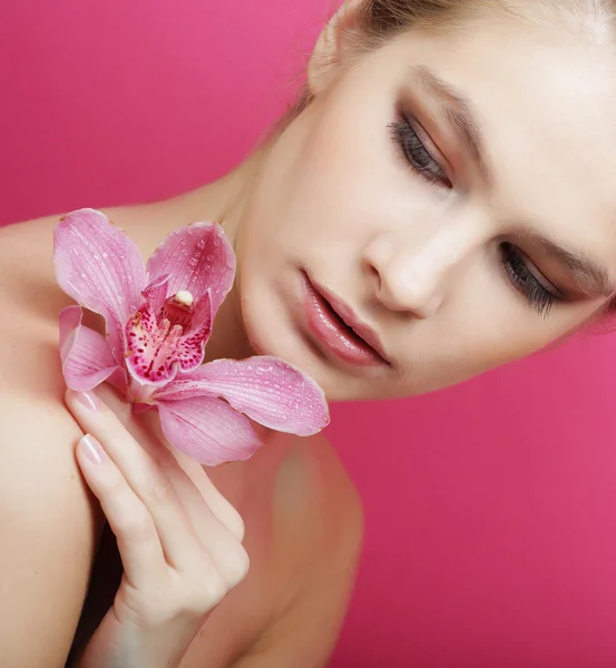 Beautiful happy woman with orchid flower Stock Photo