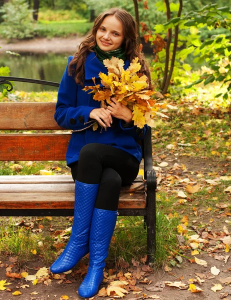 Young elegant woman with autumn leaves — Stock Photo, Image
