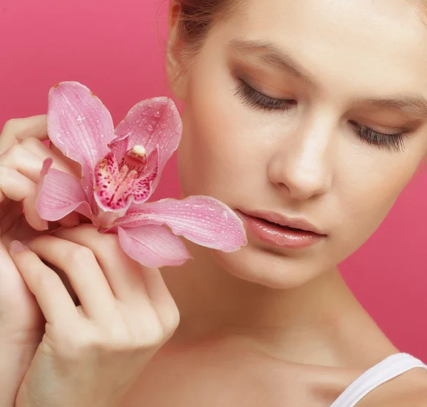 Beautiful happy woman with orchid flower — Stock Photo, Image
