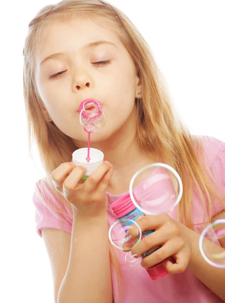 Funny lovely little girl blowing soap bubbles — Stock Photo, Image