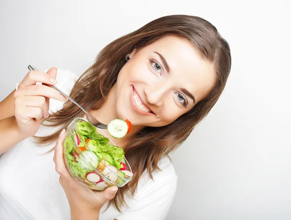 Girl with a salad on a white background — Stock Photo, Image