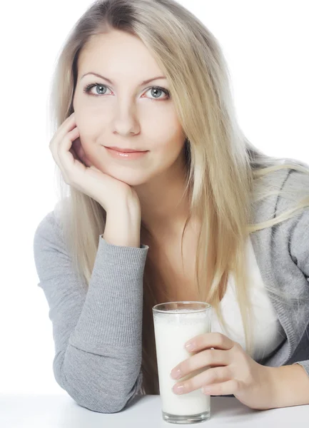 Young woman holding a glass of fresh milk Stock Picture
