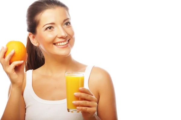 Young happy woman drinking orange juice Royalty Free Stock Images