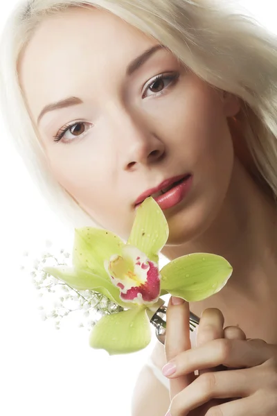 Blonde vrouw met groene orchideebloem — Stockfoto