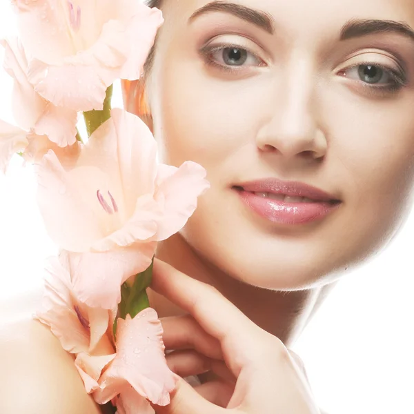 Fresh face with gladiolus flowers in her hands Stock Photo