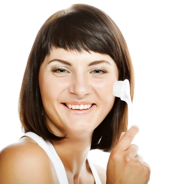 Girl cleaning face with peeling brush — Stock Photo, Image