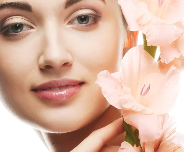 Fresh face with gladiolus flowers in her hands — Stock Photo, Image