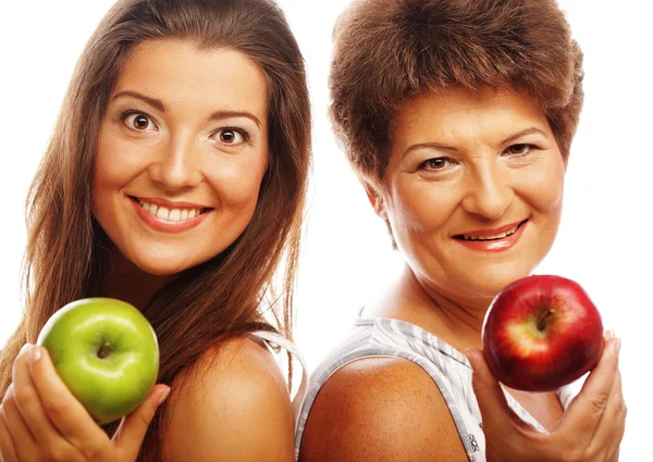 Middle age woman with her daughter holding apples — Stock Photo, Image