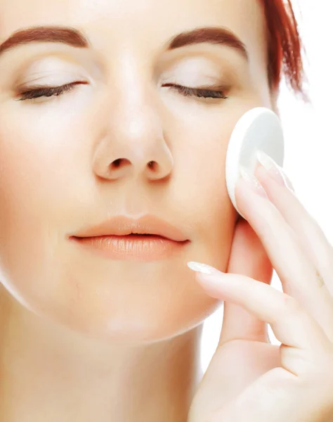 Young woman applying a creme on her face — Stock Photo, Image