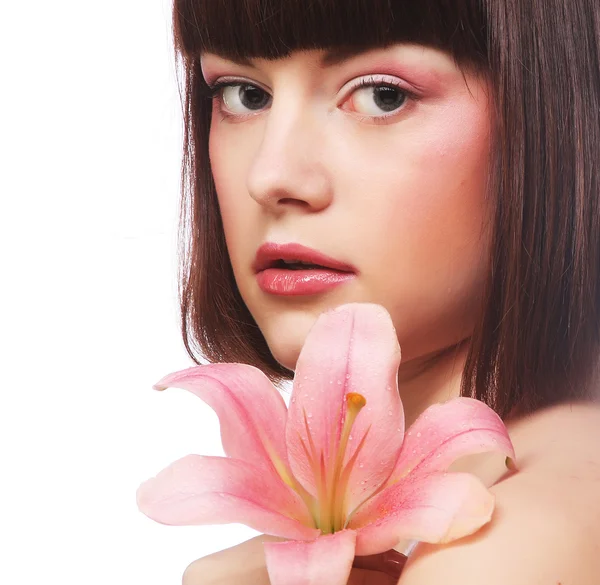 Beautiful woman with pink flower — Stock Photo, Image