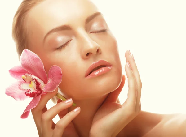 Mujer joven con orquídea rosa — Foto de Stock