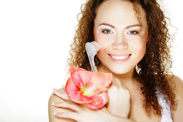 Beautiful spa girl holding pink flower and brush — Stock Photo, Image