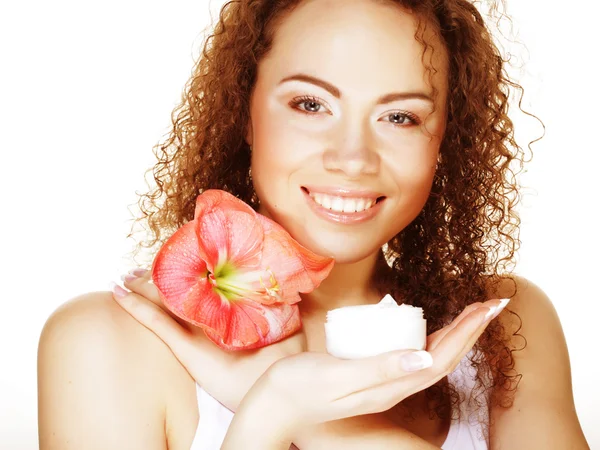 Beautiful spa girl holding pink flower and cream — Stock Photo, Image