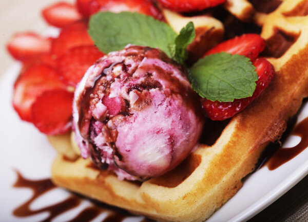delicious waffles with strawberry and ice cream