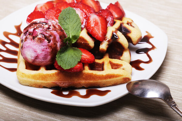 delicious waffles with strawberry and ice cream