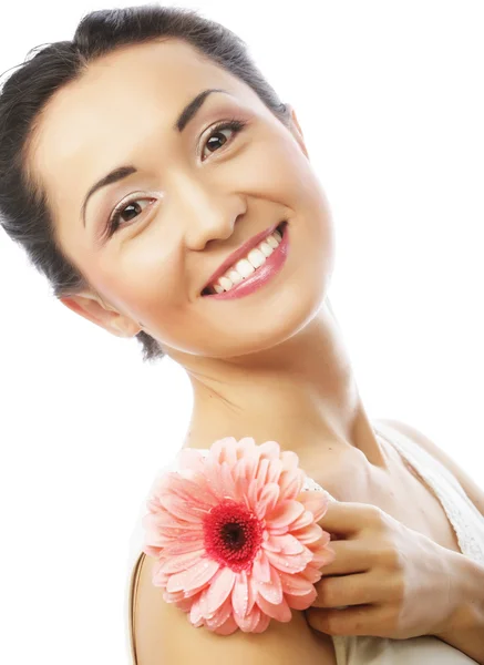 Happy asian woman holding a pink gerbera — Stock Photo, Image