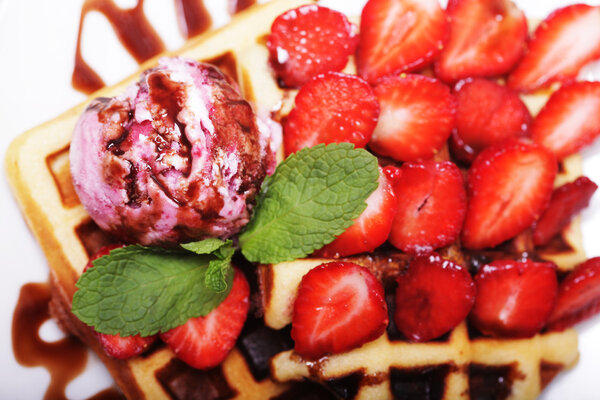 delicious waffles with strawberry and ice cream