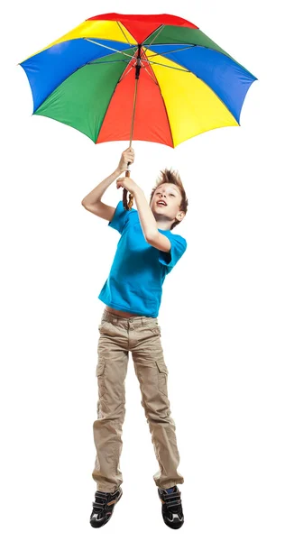 Beautiful funny boy in t-shirt holding a multicolored umbrella flying high — Stock Photo, Image
