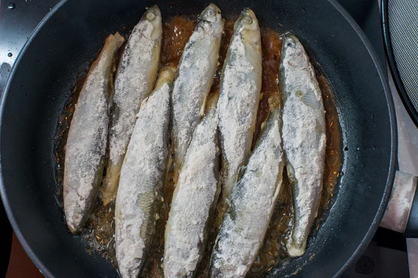 Pequeno peixe saboroso cheiroso frito em um prato quente de churrasco — Fotografia de Stock