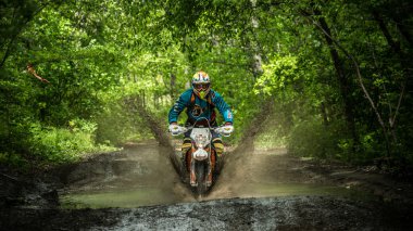 enduro moto büyük bir sıçrama ile çamur içinde