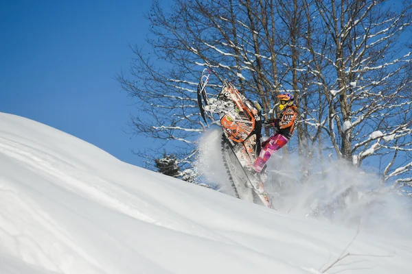 Moto de nieve en el bosque de invierno en las montañas — Foto de Stock