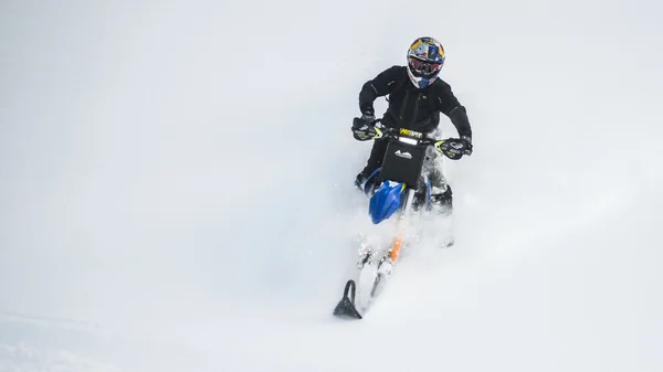 Snowmobile in winter forest in the mountains of Sakhalin Island — Stock Photo, Image