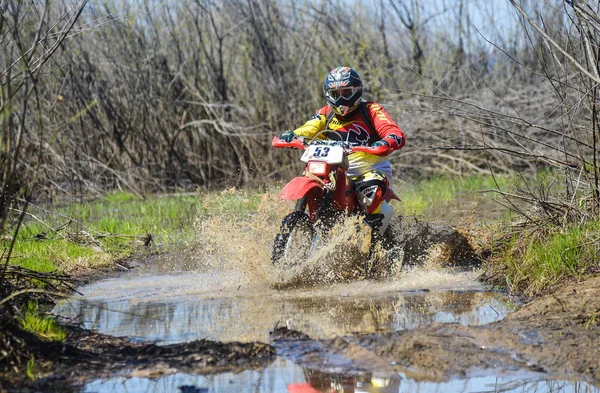 Enduro motorcycle rides through the mud with a big splash — Zdjęcie stockowe