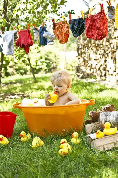 Baby bathing in the garden Stock Picture