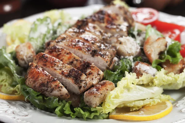 Spicy grilled chicken with caesar salad — Stock Photo, Image