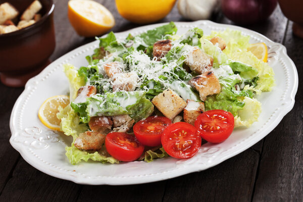 Caesar salad with lemon and cherry tomato
