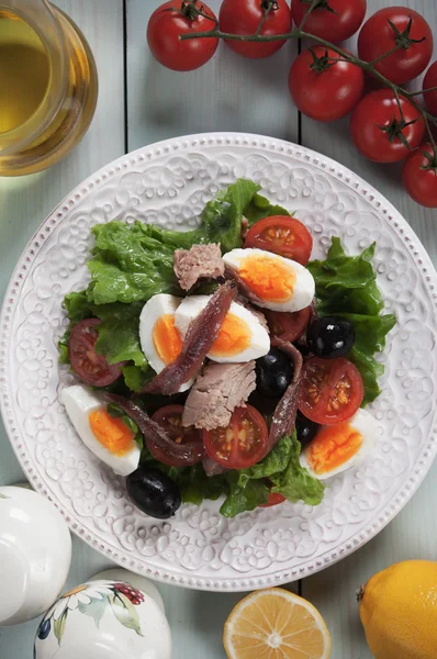 Nicoise salad with tuna, anchovy, eggs and olives — Stock Photo, Image