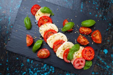 Peynirli, domatesli ve fesleğenli taze İtalyan caprese salatası.