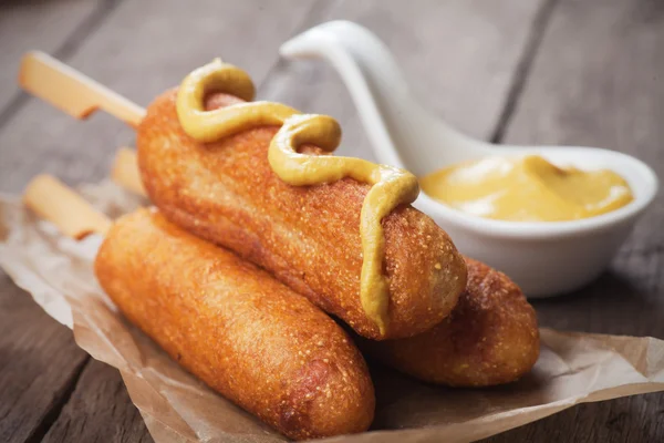 Corn dog with mustard — Stock Photo, Image