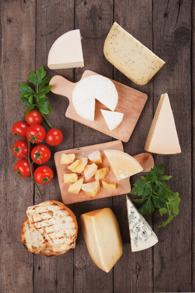 Assorted cheese on wooden platter