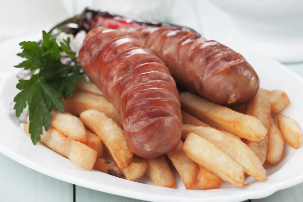 Grilled sausages with french fries — Stock Photo, Image