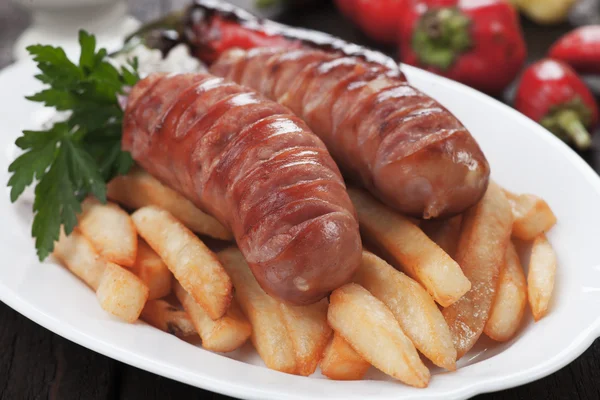 Grilled sausages with french fries — Stok fotoğraf