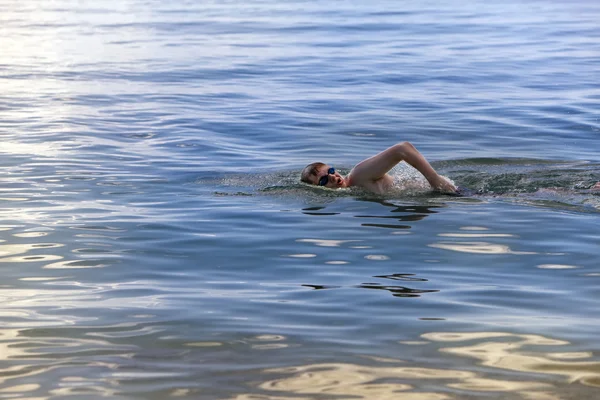 Jeune homme sportif nage dans la mer — Photo