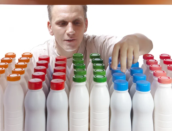 The man selects dairy products in the shop — Stock Photo, Image