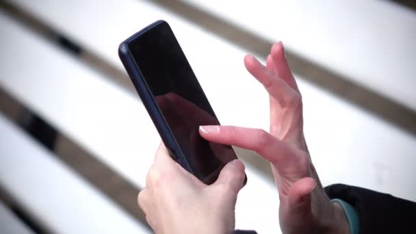 Vrouw alleen handen met behulp van touchscreen op de telefoon — Stockvideo