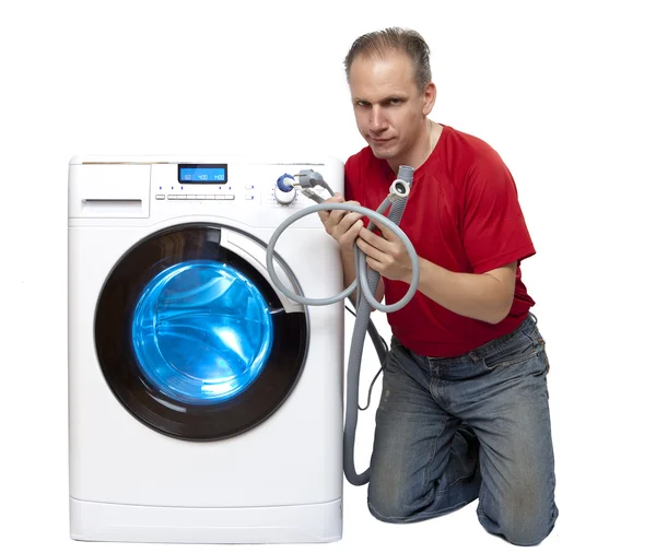 The man who has thought of repair or connection of the washing machine near the new washing machine — Stock Photo, Image