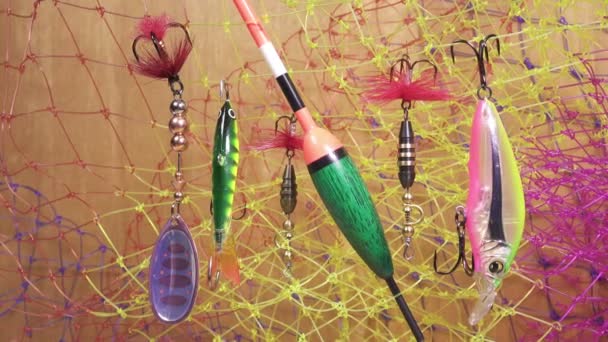 Float and baits on a fishing net background — Stock Video