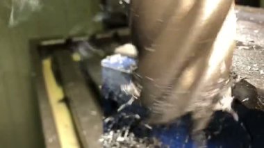Metal işçiliği. Son değirmen kesicisi, makine parçalarını evrensel dikey değirmen makinesine kaldırır.