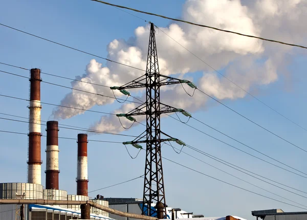 Pipe with smoke and line of electricity transmission on background — Stock Photo, Image