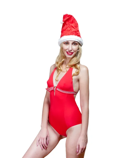 The beautiful woman in a red bathing suit and a red cap of Santa Claus — Stock Photo, Image
