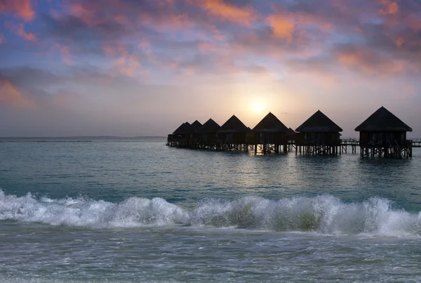 Villa on piles on water at the time sunset. Maldives. — Stock Photo, Image