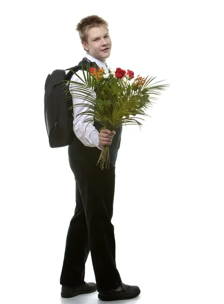 L'élève des classes supérieures en uniforme scolaire avec un bouquet de fleurs — Photo