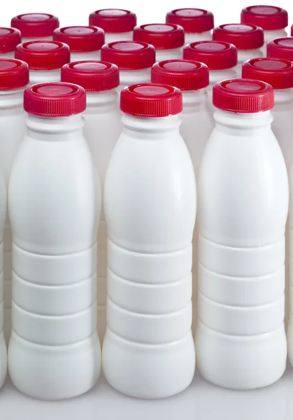 Dairy products bottles with bright covers — Stock Photo, Image