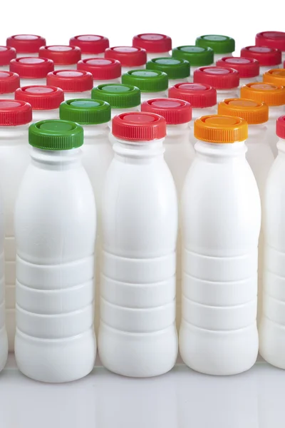 Dairy products bottles with bright covers — Stock Photo, Image